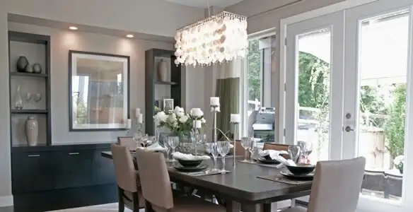 Elegant dining room chandelier installation above table in Charleston, SC