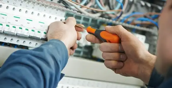 electrical service showing licensed electrician performing electrical panel maintenance and adjustments in Charleston, SC