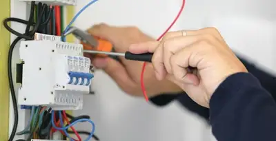 Electrician installing and adjusting circuit breakers in an electrical panel in Charleston, SC