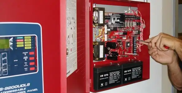 fire alarm installation service showing technician configuring fire alarm control panel in Charleston, SC