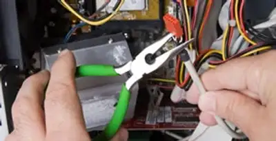 Licensed electrical contractor performing electrical repair with tools in Mount Pleasant, SC