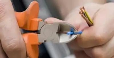 professional electrical services showing precise wire cutting by licensed electricians in Charleston, SC