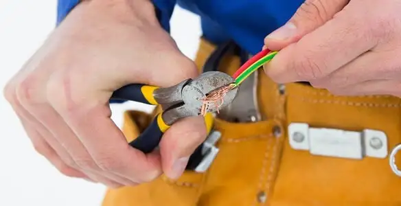 licensed electrician securing electrical wiring with professional tools during service work in Charleston, SC