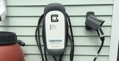 Outdoor electric vehicle charger installation on residential wall in Charleston, SC