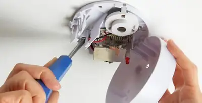 Certified technician wiring smoke detector during installation in Charleston, SC